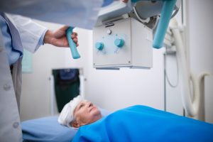Senior woman undergoing an x-ray test in hospital